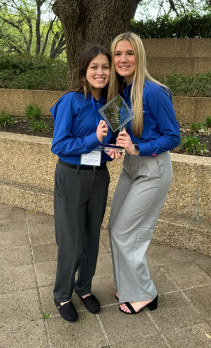 Two KCAL TSA students pose with the State Championship trophy.